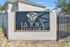 Inviting entrance sign to La Joya Apartments, set against a modern architectural backdrop, promising comfort and elegance.