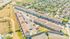 Vibrant aerial view of a well-structured apartment complex with ample parking and scenic surroundings, perfect for modern living.
