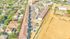 Vibrant aerial view of a lively apartment complex surrounded by lush greenery, showcasing convenient parking and a bustling neighborhood atmosphere.