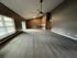 Elegant and spacious living area with high ceilings, large windows, and sleek flooring, perfect for a modern lifestyle.