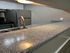 Modern kitchen with sleek granite countertops, stainless steel sink, and contemporary appliances.