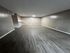 Spacious apartment with elegant wood flooring, neutral wall tones, and cozy lighting, perfect for a modern living space.