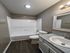 Modern bathroom with elegant lighting, a sleek bathtub, and stylish vanity, offering a serene space for relaxation.