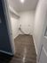 Contemporary laundry room with sleek hardwood floors and ample storage potential, offering a perfect space for organizing.