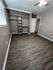 Chic, modern bedroom with elegant wood flooring and a spacious built-in closet, offering ample storage.