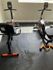 Two modern recumbent exercise bikes in the fitness center at Trailwood Village Apartments in Kingwood, TX, featuring orange and black low-impact cardio equipment.