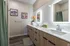 Sleek bathroom with dual sinks, illuminated mirrors, and contemporary fixtures.