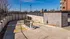 Secure and modern parking entrance with a gated barrier and view of city skyline.