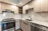 Contemporary kitchen with stainless steel appliances and elegant wooden cabinets.