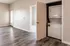 Contemporary apartment interior featuring sleek laminate flooring and built-in washer and dryer unit.