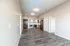 Modern apartment interior featuring a spacious open floor plan with wooden flooring, stylish kitchen cabinets, and stainless steel appliances.