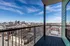 Breathtaking urban view from a modern balcony overlooking a bustling cityscape.