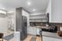 Furnished kitchen, entryway, and bathroom