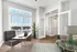 Bright office space with a modern desk, sleek chair, and a refreshing view through tall windows, complemented by stylish decor and lush greenery.