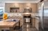 College Town, interior, kitchen, wood table, chairs, wood cabinets, stainless steel appliances, refrigerator, microwave, stove/oven
