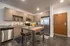 College Town, interior, kitchen, wood table, chairs, wood cabinets, stainless steel appliances, refrigerator, microwave, stove/oven, dishwasher, front door