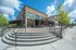 College Town, exterior, outdoor table seating, red brick building, steps to brick path