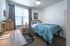 College Town, interior, bedroom, bed, desk, chair, dresser, window, blue comforter, night stand, lamp