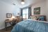 College Town, interior, bedroom, bed, desk, chair, dresser, window, blue comforter, night stand, lamp