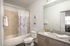 College Town, interior, bathroom, shower/tub, toilet, wood cabinets, large mirror,