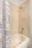 College Town, interior, bathroom, shower/tub, cream tile surround, blue and white shower curtain