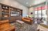 College Town, interior, seating area, gray, tan and brown leather seating, coffee table, white and gray area rugs, tv and book shelves, large windows