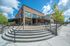 College Town, exterior, outdoor table seating, red brick building, steps to brick path