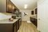 Spacious modern kitchen with dark wood cabinets and sleek countertops.