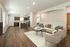 Inviting open-plan living room with a modern kitchen, cozy seating area, and stylish decor.