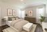 Beautifully decorated bedroom with a cozy bed, stylish artwork, and natural light accents.