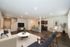 Inviting open-concept living area with modern furniture, a stylish kitchen, and a cozy seating arrangement.