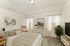 Luxurious bedroom with stylish decor, featuring a comfortable bed, modern artwork, and sleek furniture.