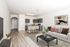 Stylish open-concept living room and kitchen with contemporary furniture and decor.