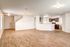 Bright open-concept living area with modern kitchen and wood flooring, ideal for entertaining.