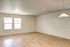 Bright and spacious living area featuring elegant hardwood floors and large windows providing ample natural light.