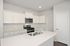 Modern kitchen with sleek white cabinetry, stainless steel appliances, and a spacious island for culinary creativity.