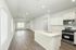 Bright and airy modern kitchen and living space with sleek hardwood floors and abundant natural light.