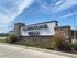 Welcoming entrance sign for Cliffstone Hills with elegant stone design and vibrant landscaping under a clear blue sky.