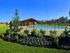 Inviting outdoor pool area with a scenic backdrop, featuring lush landscaping and a modern pergola structure.