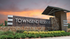 Welcome to Townsend Reserve: a scenic community entrance sign with a sunset backdrop and lush landscaping.