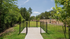 Charming fenced dog park surrounded by lush greenery, perfect for outdoor leisure.