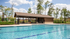 Inviting outdoor pool area with a charming pavilion, perfect for relaxation and gatherings, surrounded by lush greenery.
