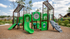 Charming playground with vibrant green slides and climbing structures, surrounded by lush greenery and modern homes, perfect for family fun.