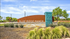Welcoming entrance sign for Blue Ridge Ranch, set against a backdrop of lush greenery and a clear blue sky.