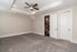 Spacious, elegant room with cozy carpeting and modern ceiling fan, perfect for a relaxing retreat.