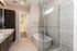 Luxurious modern bathroom with glass shower, elegant freestanding tub, and dual sinks, offering a serene and stylish atmosphere.