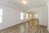 Spacious open-concept living area with elegant wood flooring and abundant natural light.