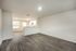 Modern open-concept living area with sleek hardwood floors and a cozy connected kitchen.