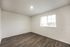 Bright and spacious room with elegant wood flooring and a large window inviting natural light.