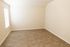 Bright and inviting empty room with elegant wooden flooring and natural light from a window, perfect for customization and decorating.
